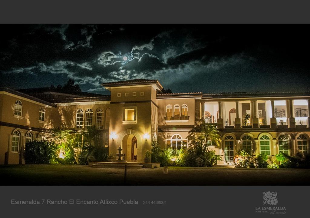 阿特利斯科埃斯梅拉达酒店的一座带灯光的大型夜间建筑