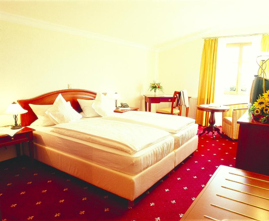 朗道因德普法尔茨Villa Hochdörffer Gästehaus的酒店客房,配有床铺和红地毯