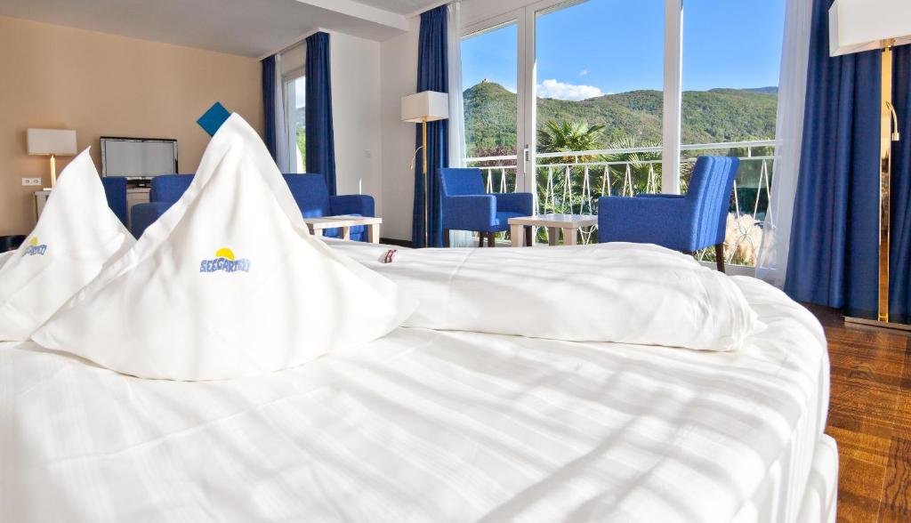 卡尔达罗随伽尔藤酒店的酒店客房带白色床和蓝色椅子
