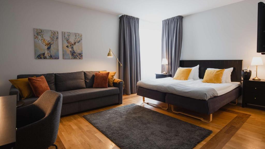 恩厄尔霍尔姆Hotell Erikslund的客厅配有床和沙发