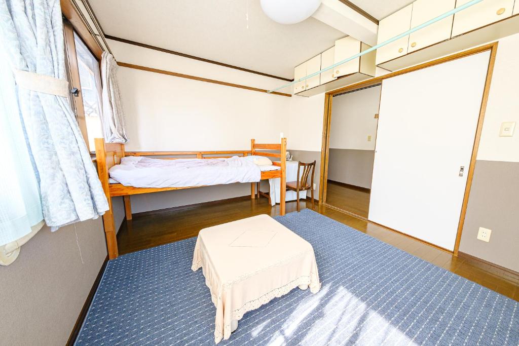 长崎渡邊民泊的小房间设有一张床和一张桌子