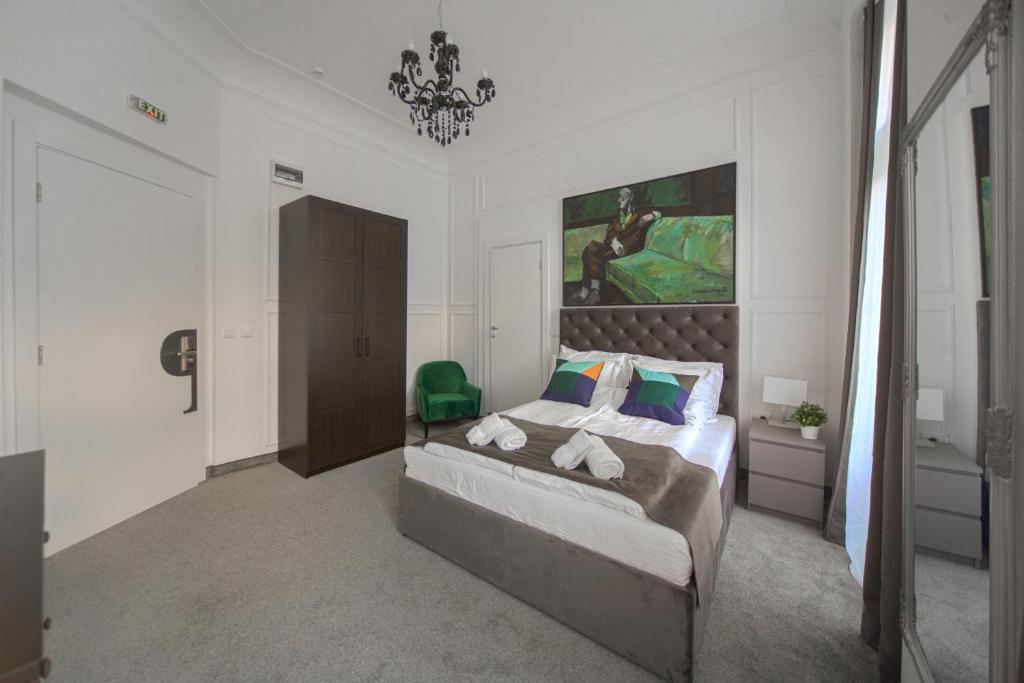 贝尔格莱德Kings Palace的卧室配有一张床,墙上挂有绘画作品