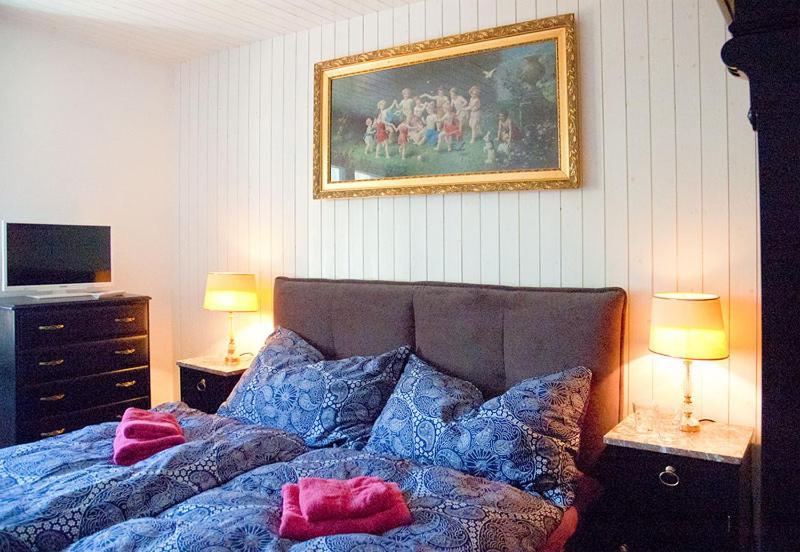 FlumsChurfirsten Blick - Private Gästezimmer的卧室配有一张床,墙上挂有绘画作品