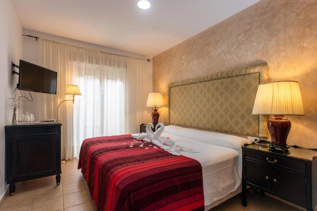 圣玛丽亚港阿拉哈海滩旅馆的酒店客房,配有一张带红色毯子的床