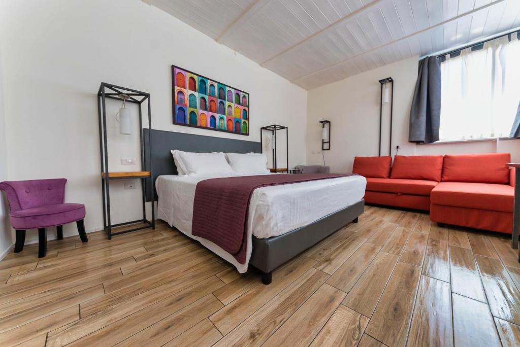 罗马Hotel Casa Mia的一间卧室配有一张床和一张红色的沙发