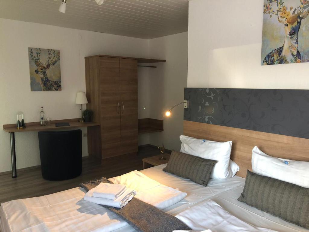 科布伦茨Hotel Berghof by 42的卧室配有一张带白色床单和枕头的大床。