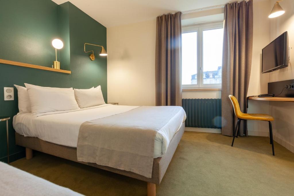 昂热格兰德酒店的配有一张床和一张书桌的酒店客房