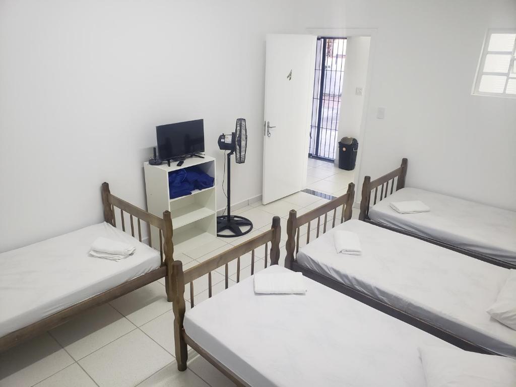 维拉可波斯Pousada alojacampinas的客房设有三张双层床和电话。