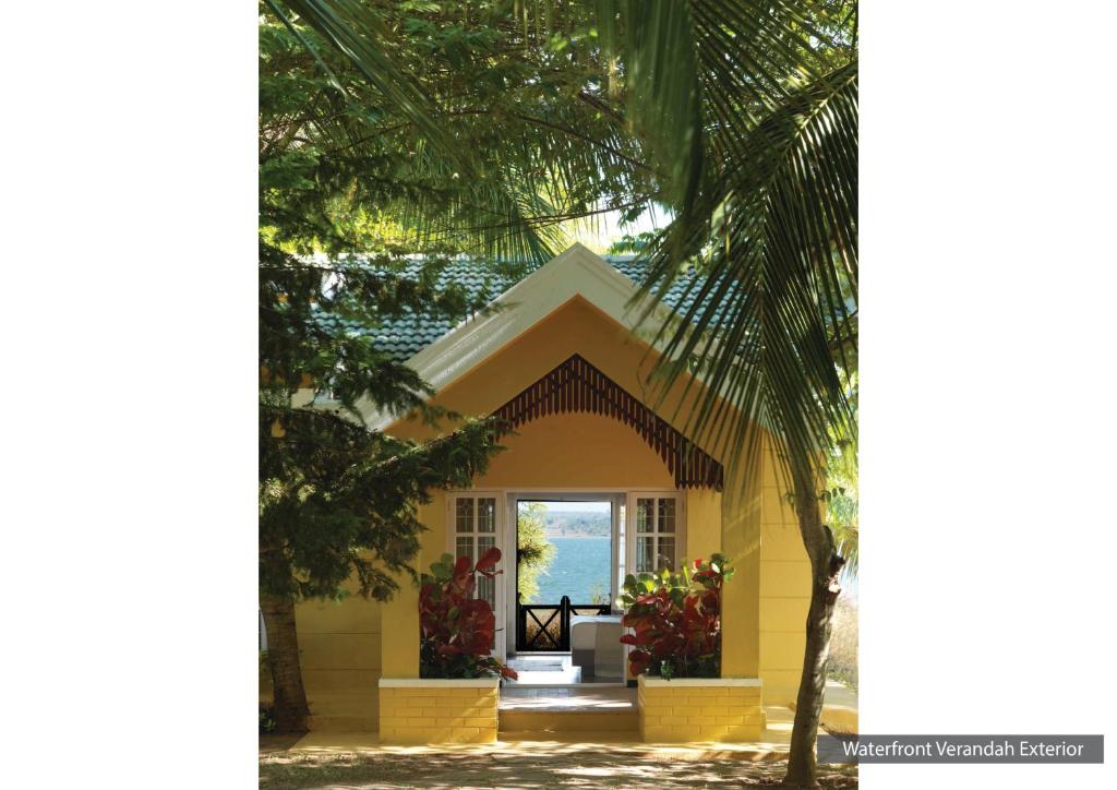 Begūr士乃卡碧尼度假村的前方有棕榈树的黄色房子