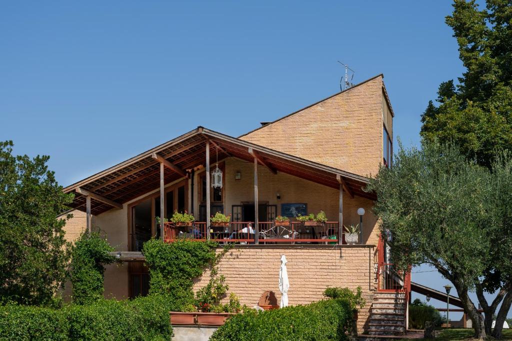 维泰博Villa dei Gelsomini, Residenza nel verde的砖屋,设有门廊和阳台