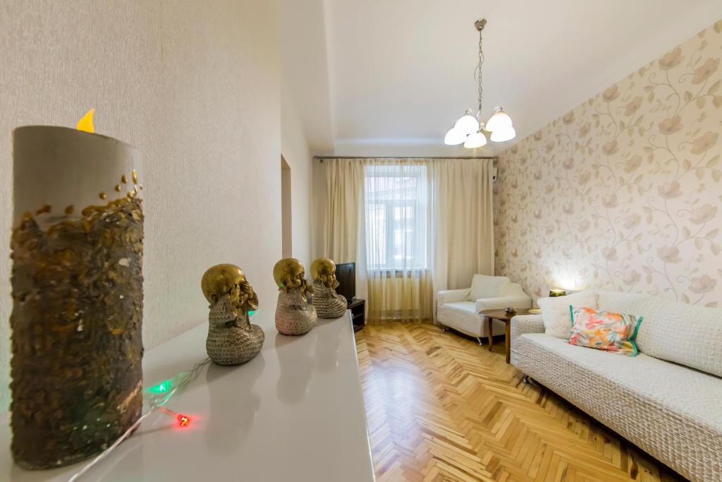 基辅Затишна квартира на Майдані Незалежності的客厅配有白色的沙发和桌子