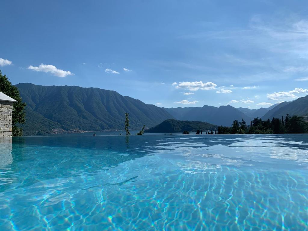特雷梅佐La Filanda di Viano in Villa的一大片水体,背景是群山