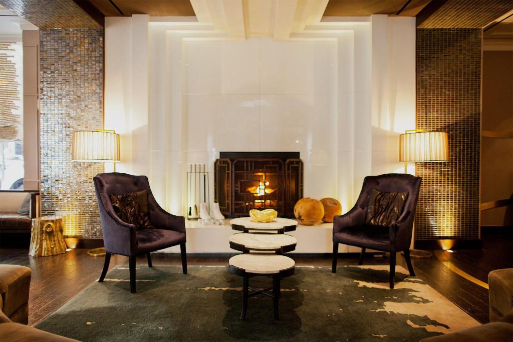 费城费城帕洛马金普顿酒店的客厅配有两把椅子和壁炉