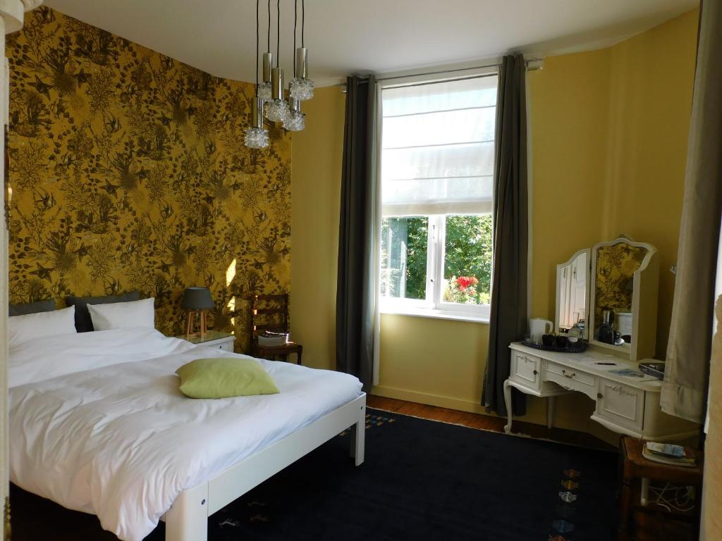 布兰肯贝赫多宏特住宿加早餐旅馆的一间卧室配有一张带镜子的床和窗户