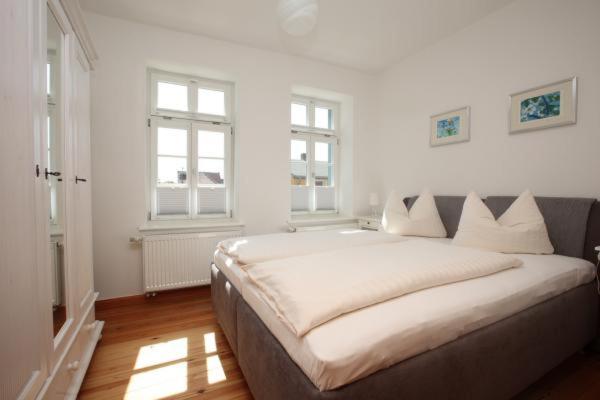 欧巴德伍斯图Gästehaus Schimmel´s的白色的客房设有大窗户,配有一张大床。