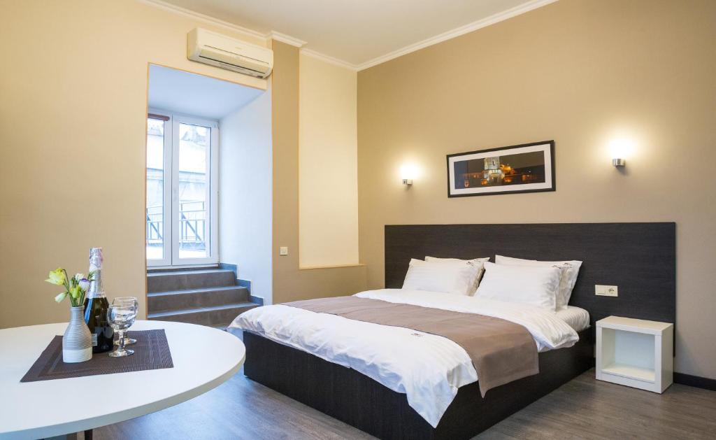 基辅Khreshchatyk Apart Hotel Passage的一间卧室配有一张床和一张桌子