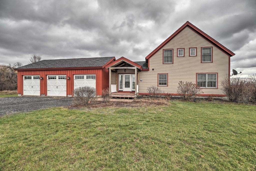 AlburgWaterfront Home with Dock and Beach on Lake Champlain!的一座大型房子,设有红色和白色的车库