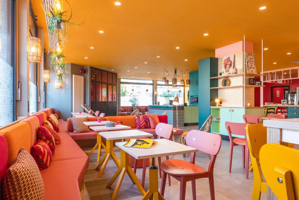 科尔马PAUL & PIA - Welcome Home Hotel的一间带沙发和桌椅的餐厅
