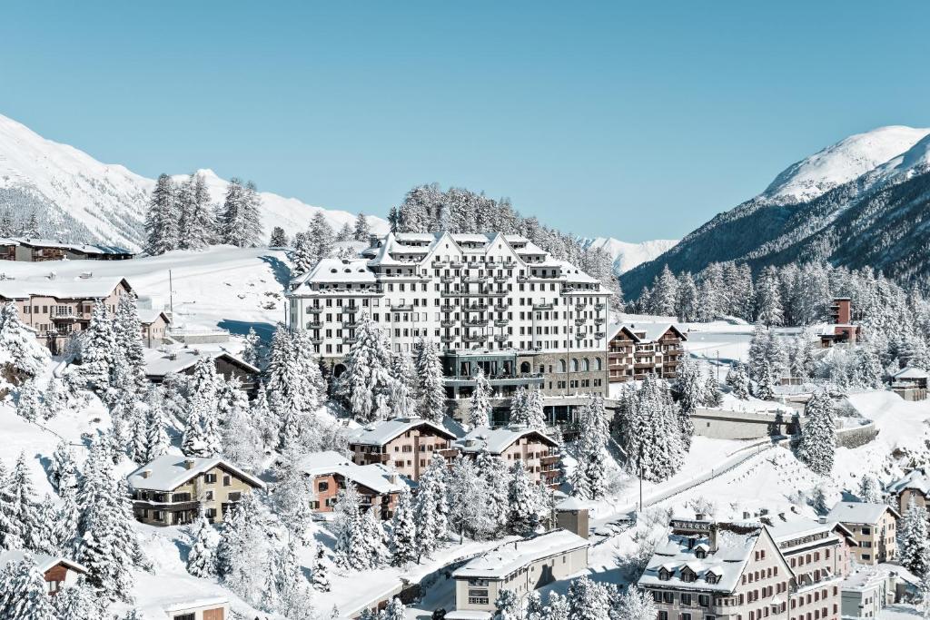 圣莫里茨Carlton Hotel St Moritz - The Leading Hotels of the World的雪覆盖的山间度假村