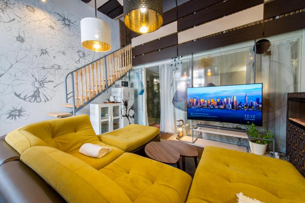 卡拉甘达Inn OZZ的客厅设有黄色沙发和电视