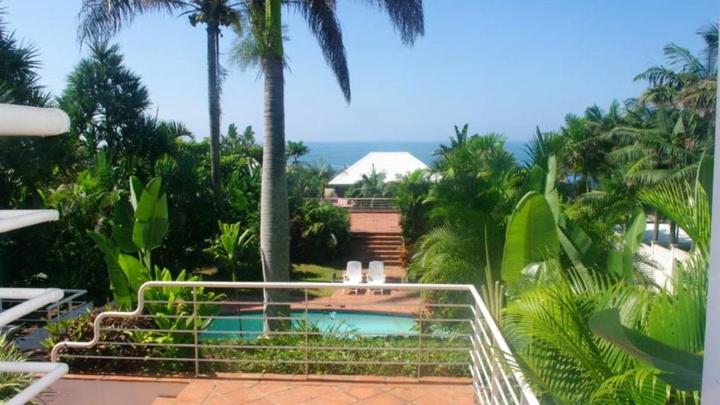 斯坦格Thoko-Zani Beach House的棕榈树度假村内的游泳池