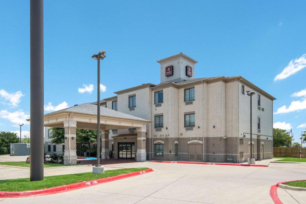 韦瑟福德Clarion Inn & Suites Weatherford South的一座建筑的顶部有一个钟楼