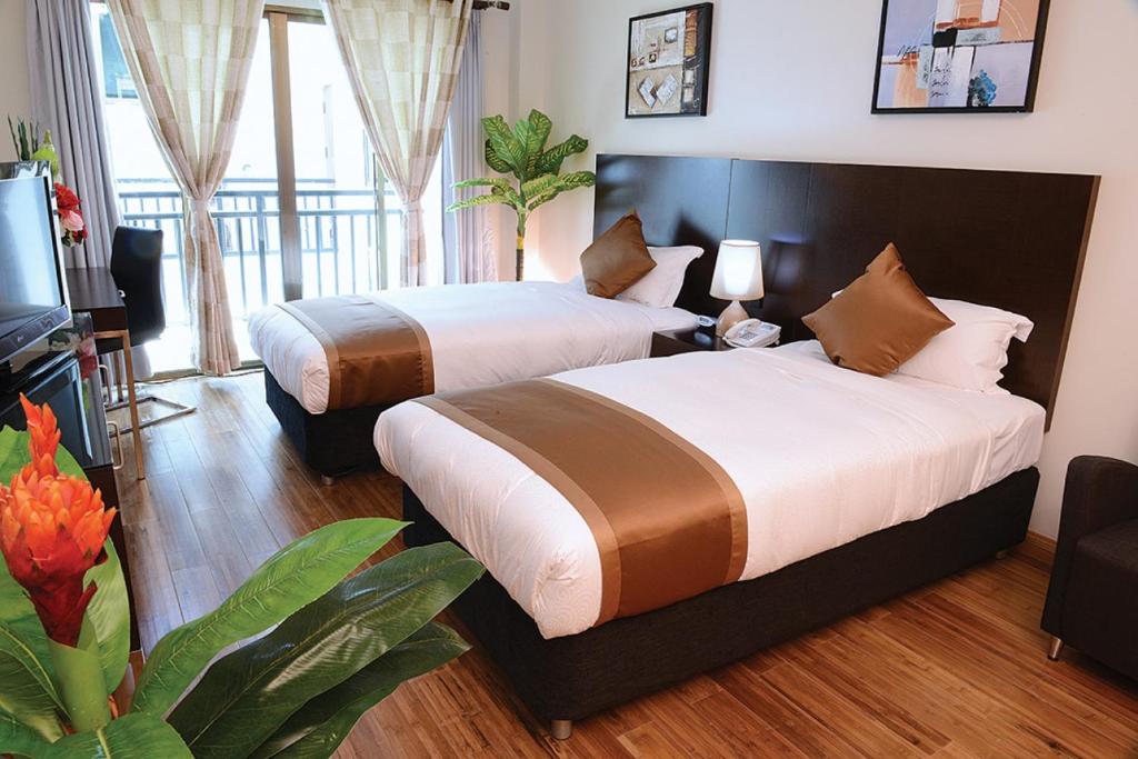 帝力帝汶广场公寓酒店的两间位于酒店客房的床铺,
