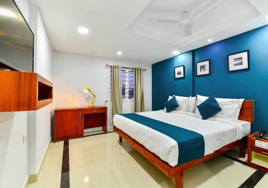 科钦The Reach Hotel的蓝色和白色的卧室设有一张大床