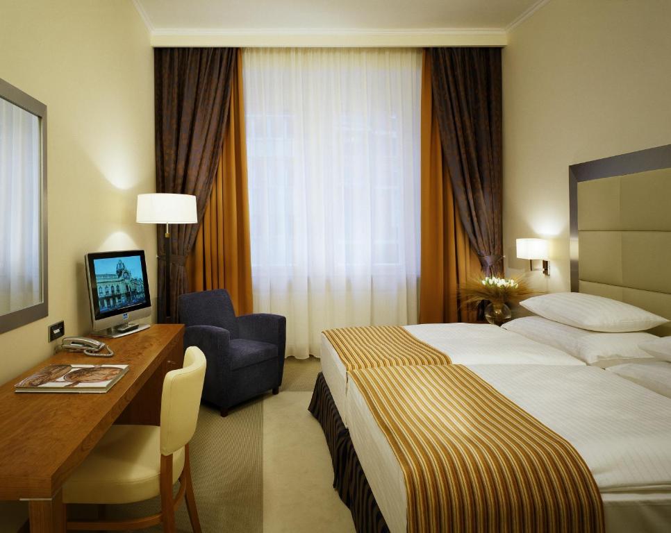 布拉格梅瑞恩设计酒店的酒店客房配有一张床和一张带电脑的书桌