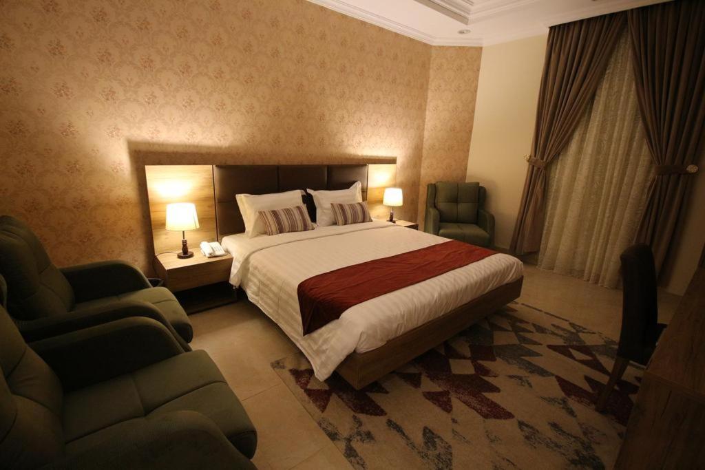 麦地那Assilah Hotel的酒店客房,配有一张床和两把椅子