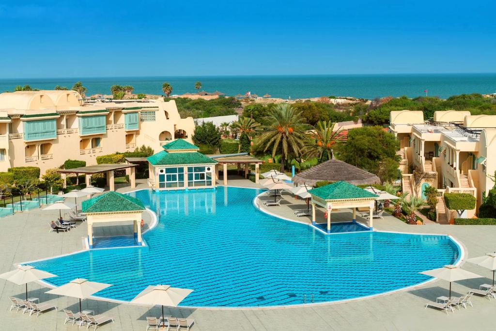 迦玛特迦太基海水浴酒店的享有带遮阳伞的大型游泳池的顶部景致