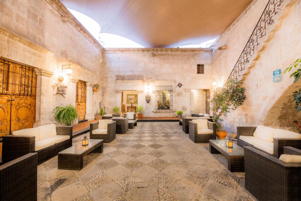 阿雷基帕Hotel Los Tambos Colonial的大厅,在大楼里设有沙发和桌子