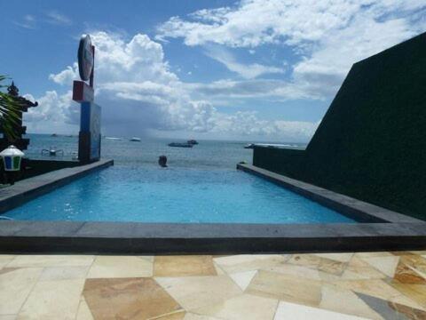 蓝梦岛乐伯甘马德旅馆的一个大型的游泳池,背景是大海