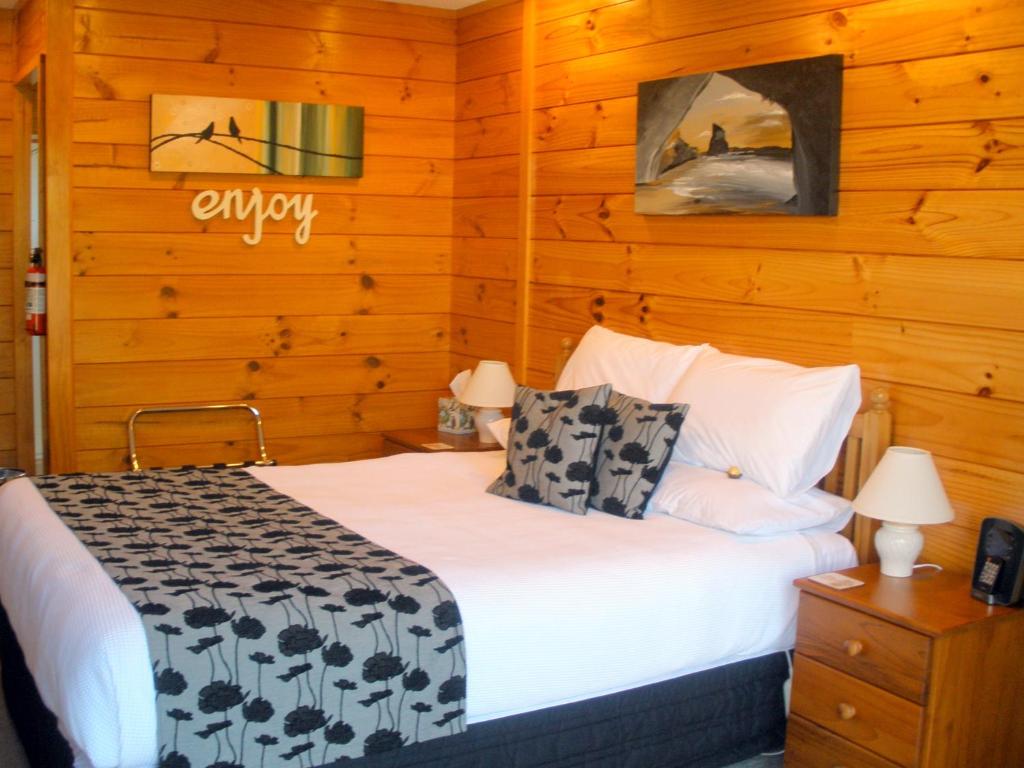 怀蒂昂格安德里亚住宿加早餐旅馆的一间卧室设有一张床和木墙
