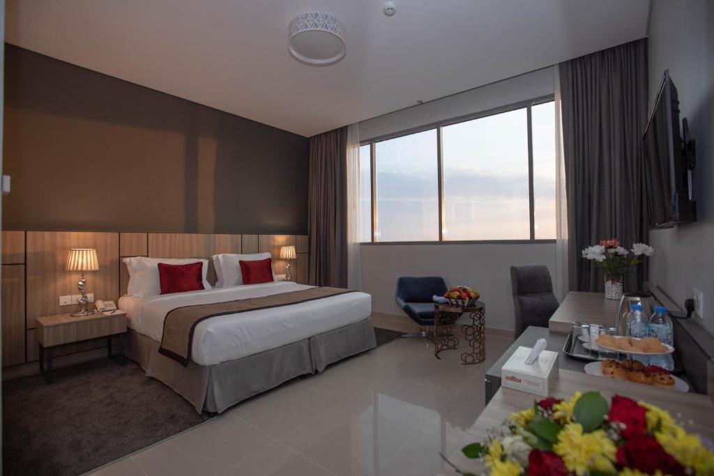 富查伊拉Fortis Hotel Fujairah的酒店客房设有床和客厅。