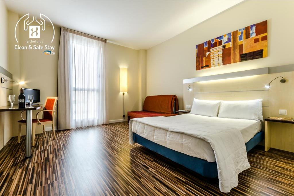 萨拉戈萨YIT萨拉戈萨酒店的配有一张床和一张书桌的酒店客房