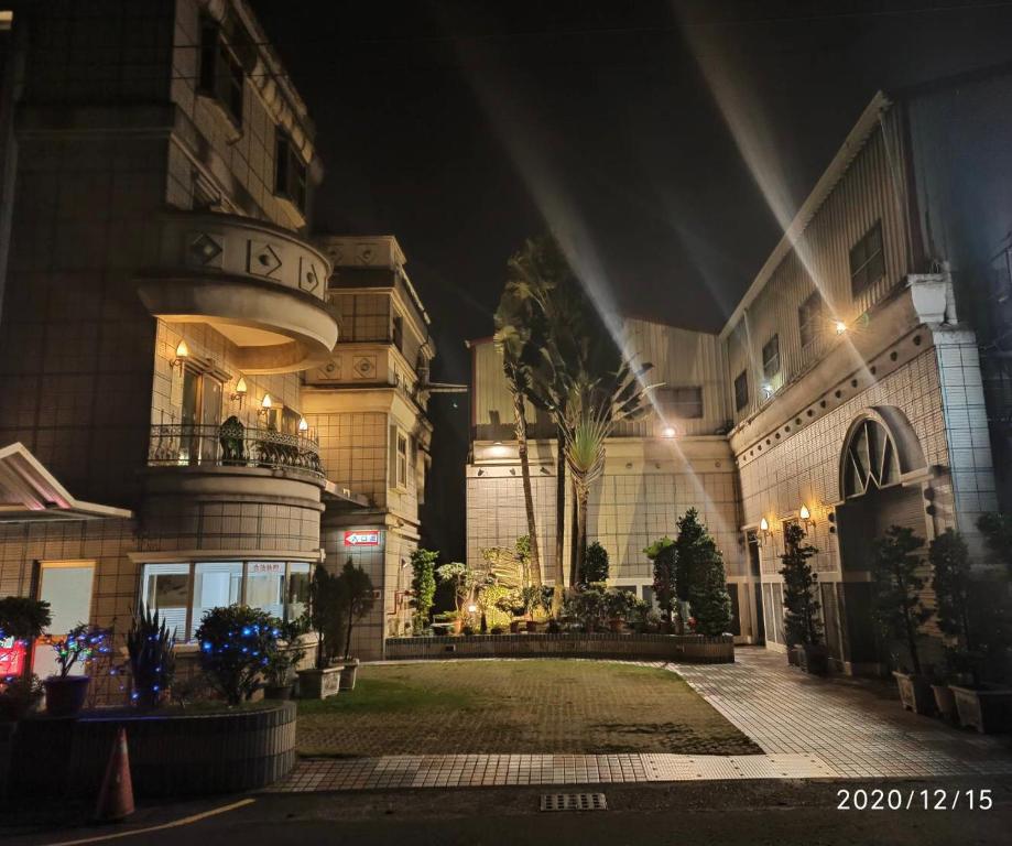 高雄艾旅汽车旅馆(2馆)的一座在晚上设有庭院的大建筑