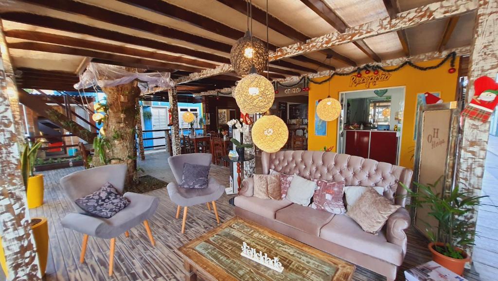 弗洛里亚诺波利斯Open House Canasvieiras - OH HOTÉIS的客厅配有沙发和两把椅子