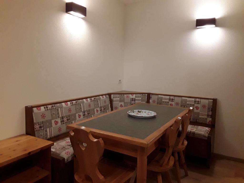 圣卡特琳娜瓦尔夫Apartments "STELLA ALPINA"的用餐室配有桌椅和灯