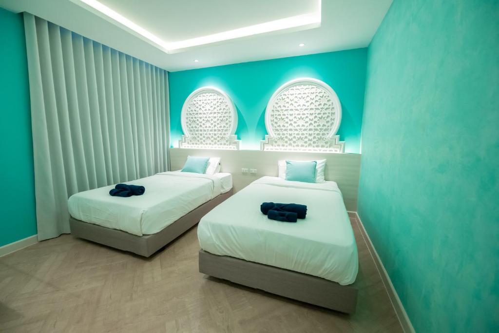 Le Maroc Hotel Patong客房内的一张或多张床位