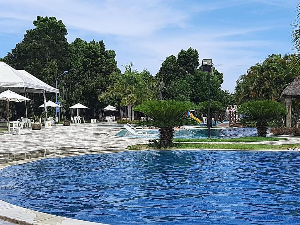 拉巴拉德纳圣米格尔Residencial Iloa的棕榈树度假村内的游泳池