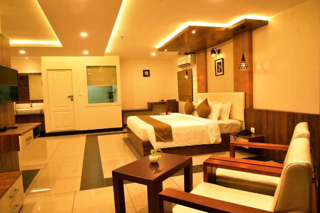 科泽科德WHITE SUITE HOTEL的酒店客房设有床和客厅。