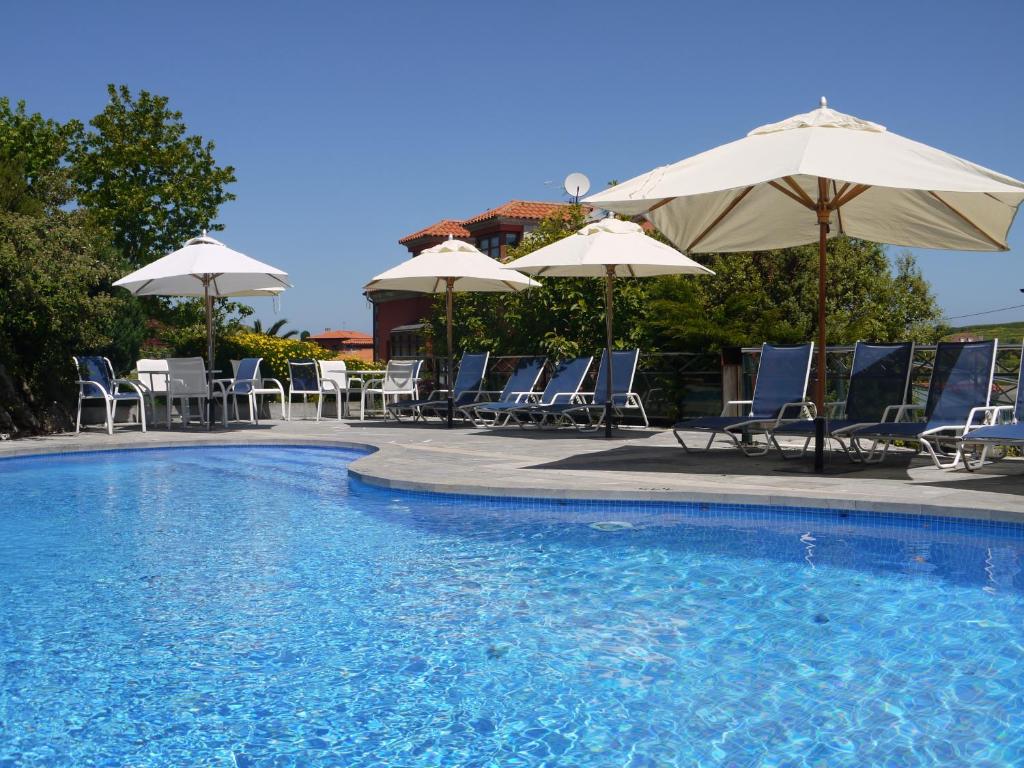 博迪利奈斯库图玛苏伽第1号公寓酒店的一个带椅子和遮阳伞的游泳池