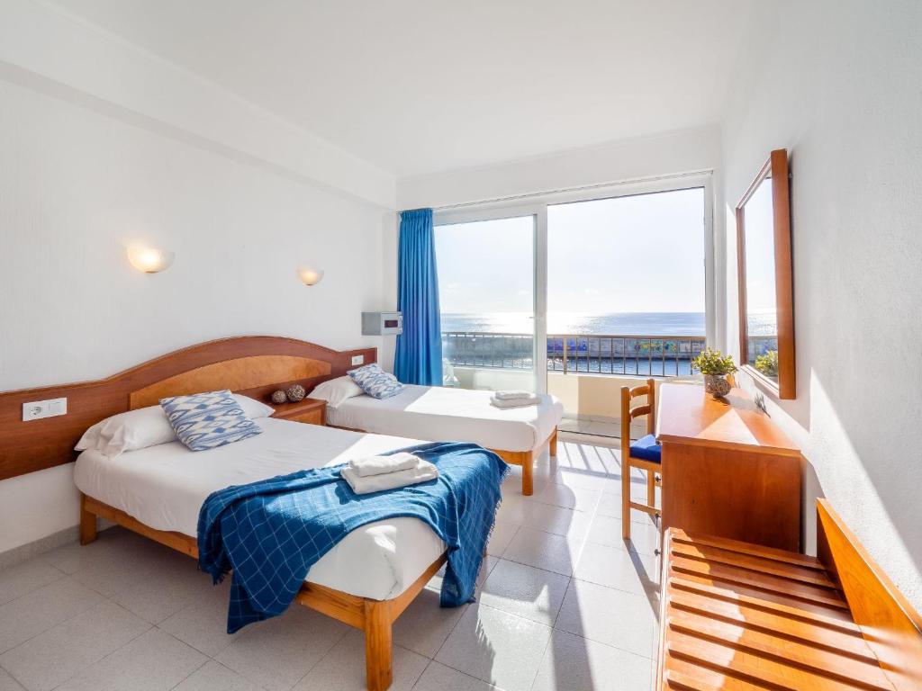 卡拉纳雅达克罗纳港旅馆的酒店客房设有两张床和一个阳台。