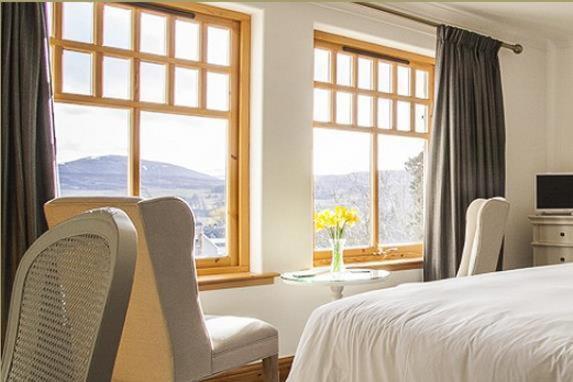 金尤西瑟泽兰旅馆的卧室配有床、桌子和窗户。