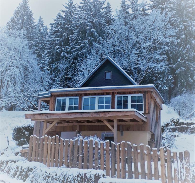 迪波尔迪斯瓦尔德Mäcky Baude的雪中带围栏的房子