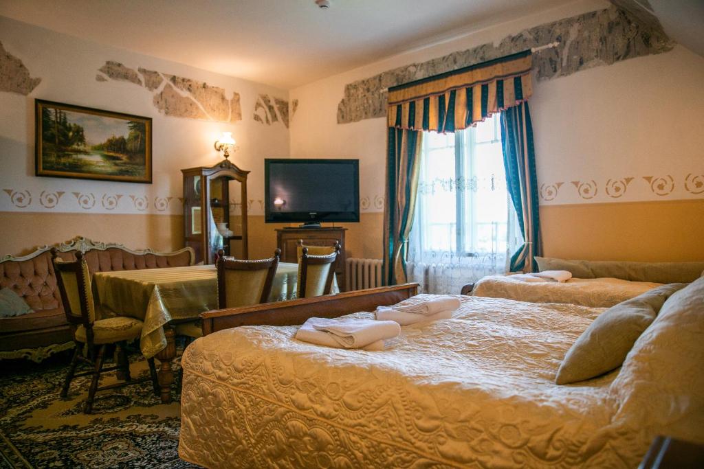 奥泰佩Cantervilla Castle的酒店客房设有两张床和电视。