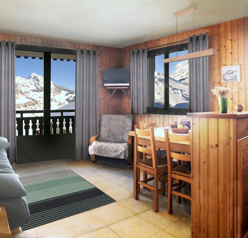 大博尔南Grand-Bo: joli appartement sur les pistes avec vue的一间带桌子和椅子的客厅,享有山景。