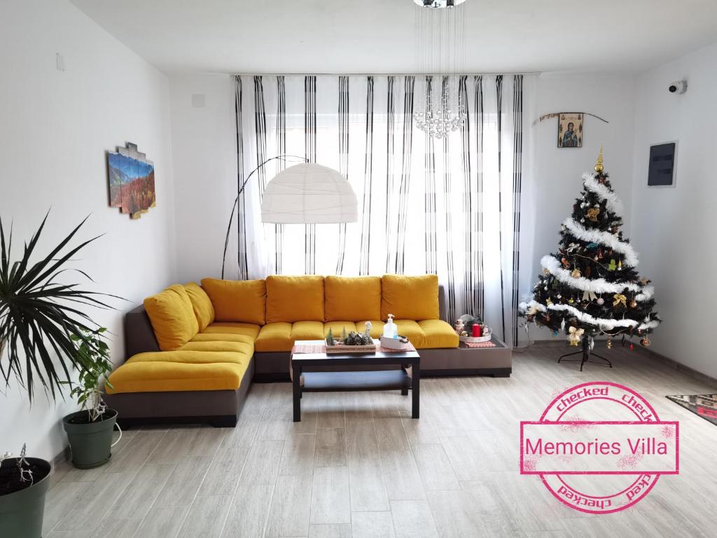 米奥修德萨斯Memories Villa的客厅设有黄色的沙发和圣诞树