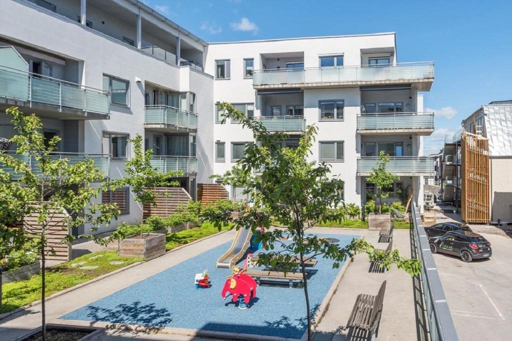 利勒斯特罗姆Modern City Apartment - Lillestrøm-Strømmen的大楼前带游乐场的公寓